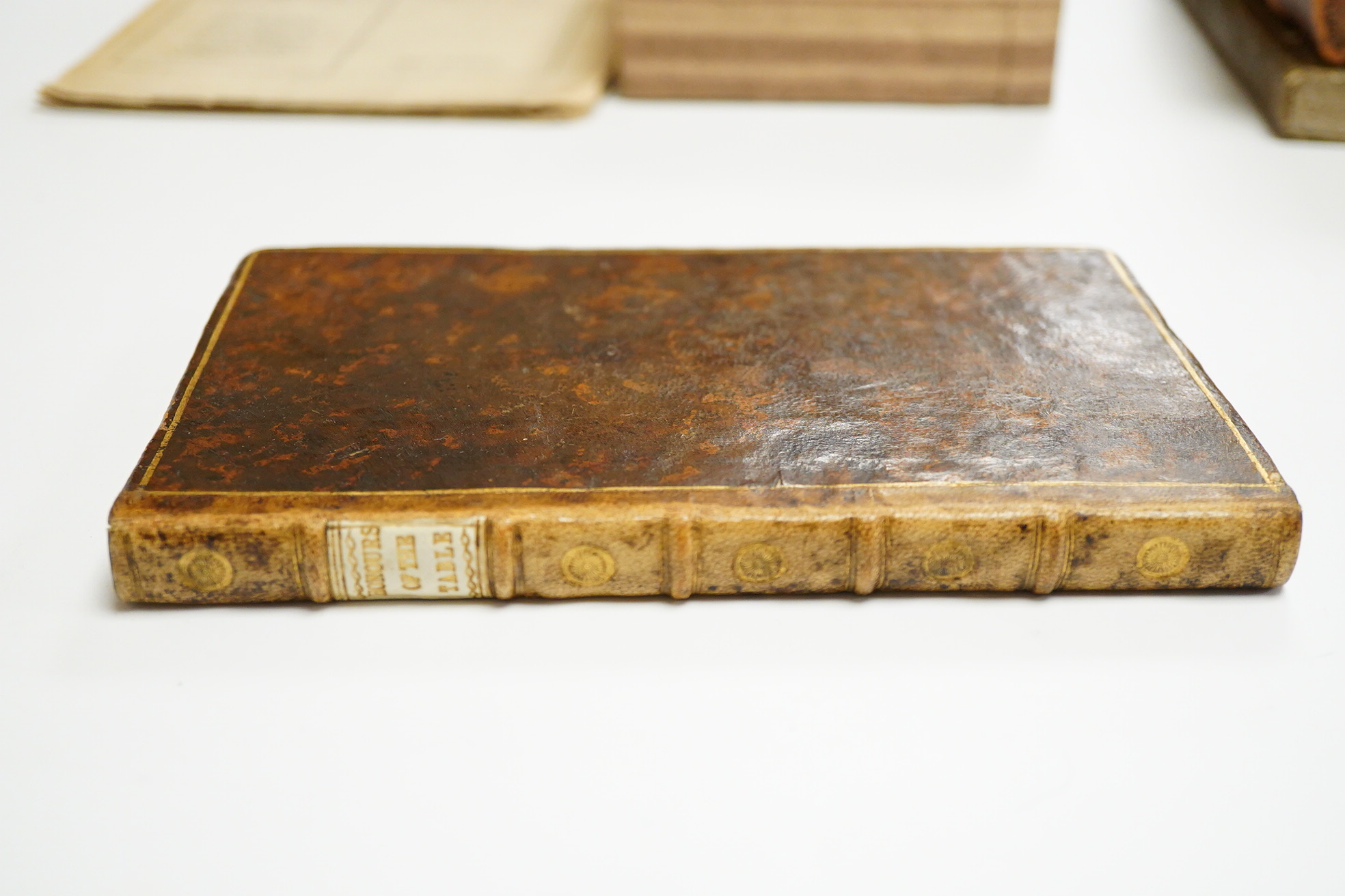 [Trusler, John] The Honours of the Table, or Rules for Behaviour during Meals; with the Whole Art of Carving ... 2nd edition. 28 engraved illus.; old mottled calf, rejointed with gilt decorated panelled spine and white l